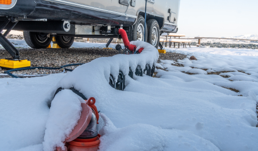RV water drain pipe in snowy winter conditions